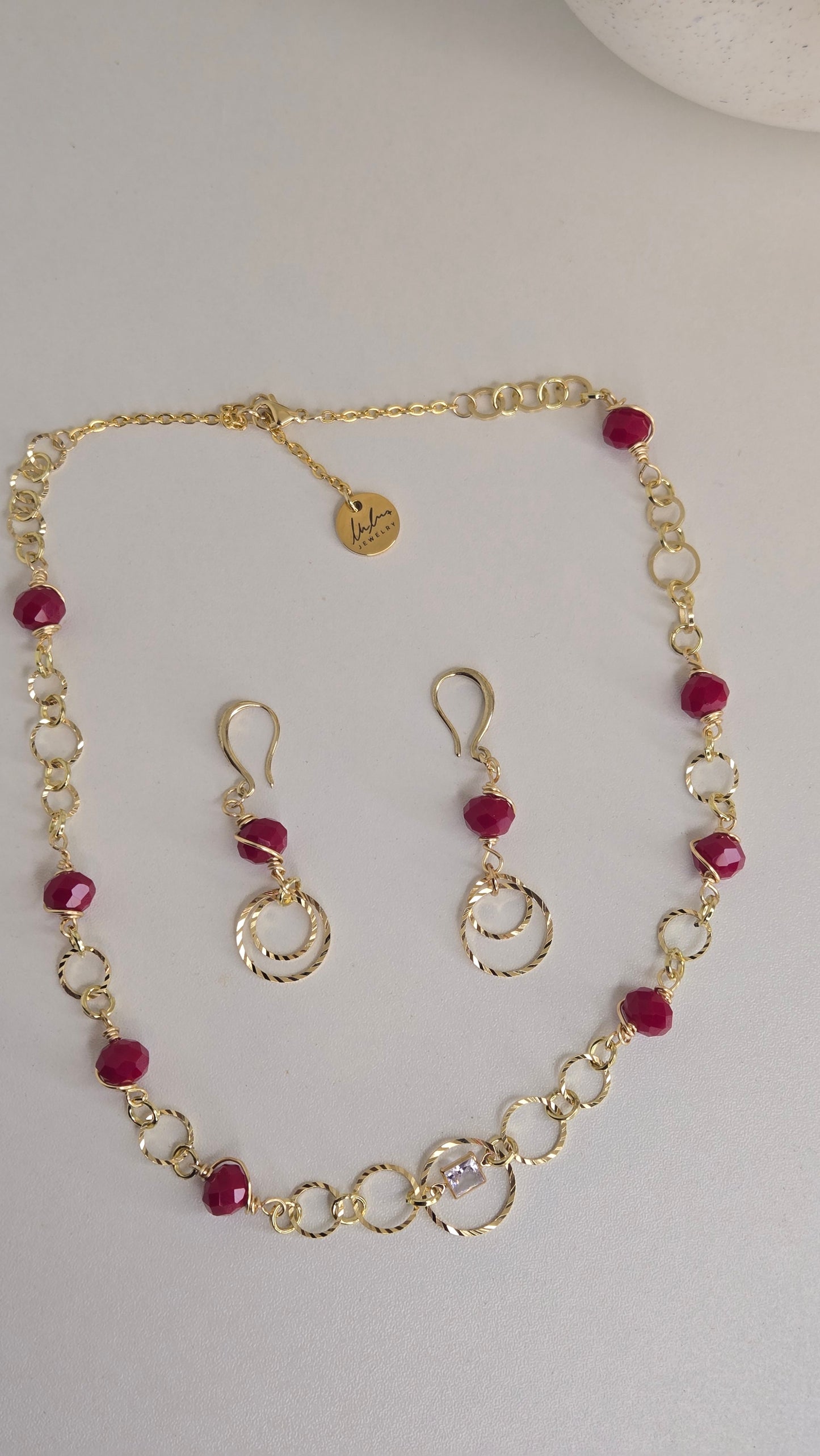 Close-up of Golden Ruby Charm Set showcasing intricate design