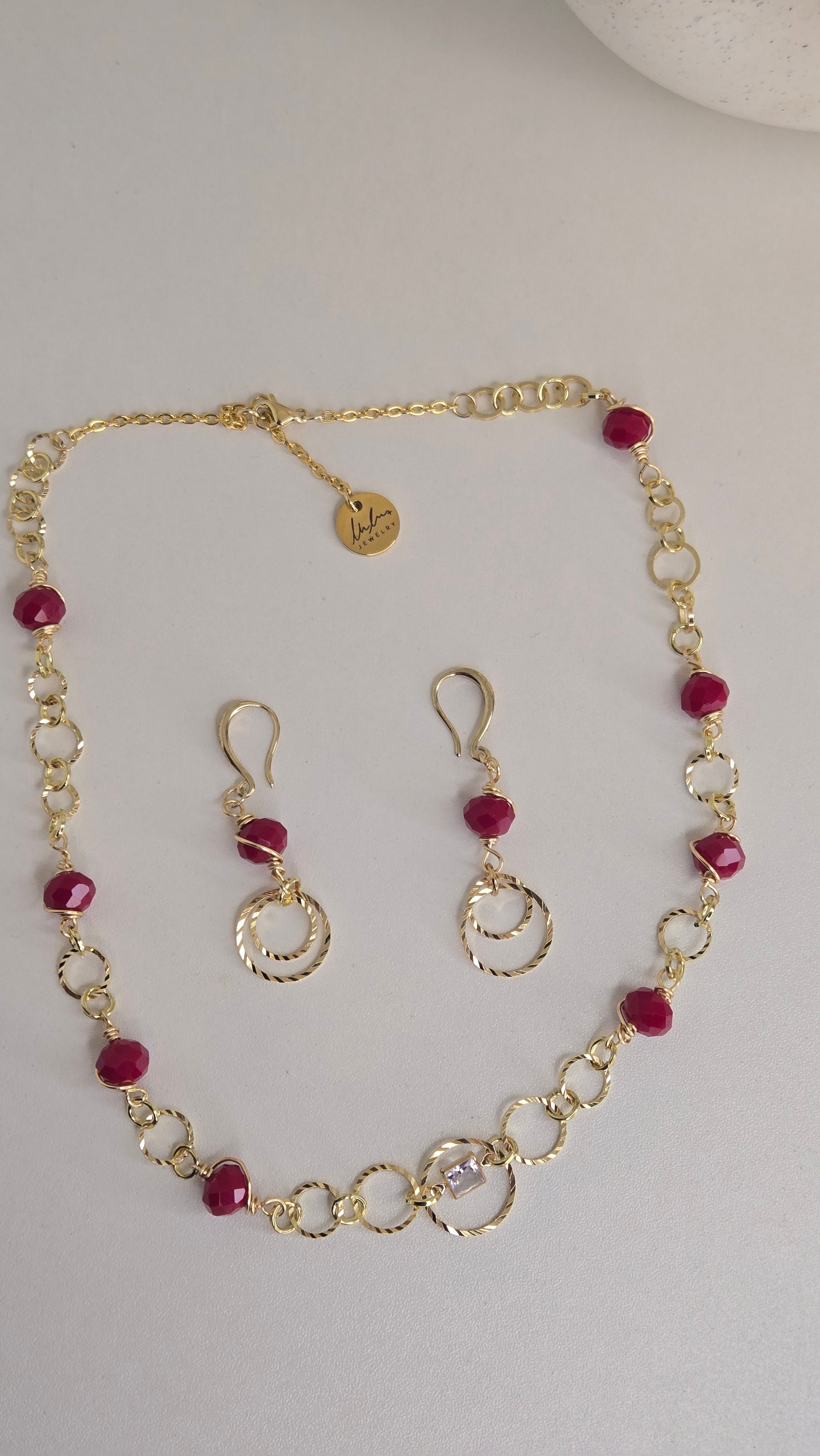 Close-up of Golden Ruby Charm Set showcasing intricate design