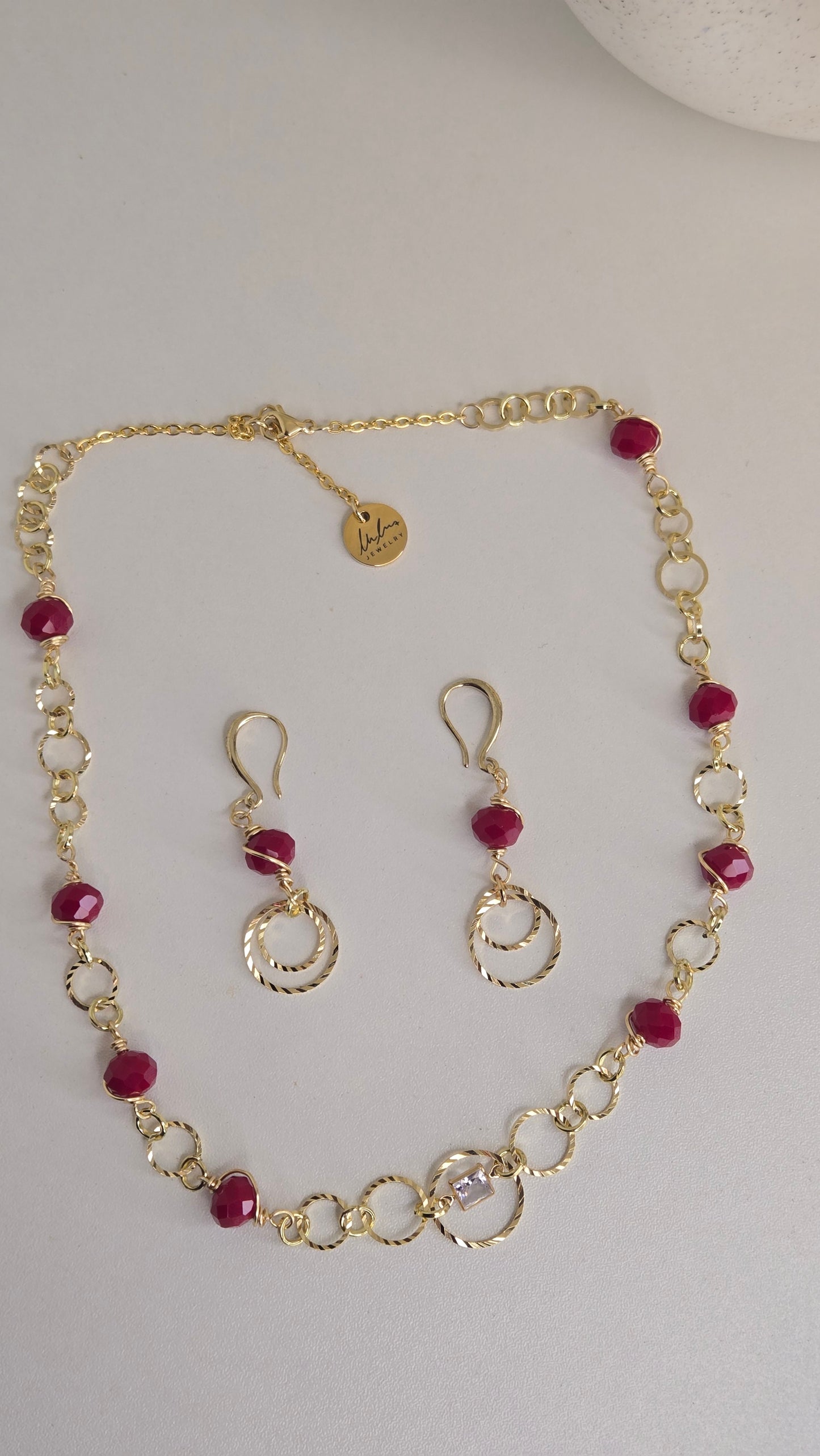 Golden Ruby Charm Set displayed elegantly with rich ruby colors