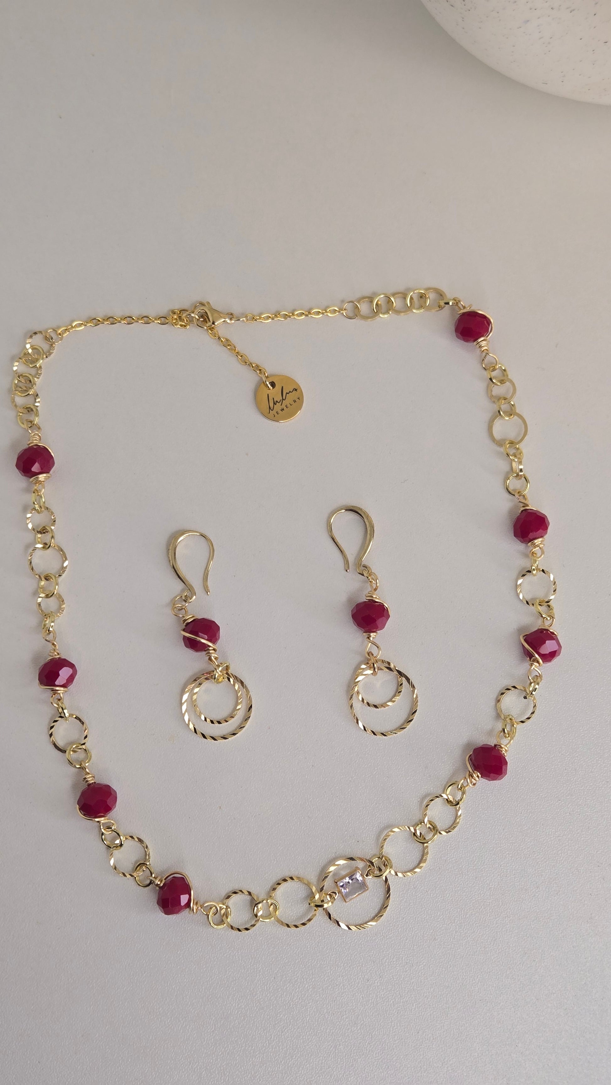 Golden Ruby Charm Set displayed elegantly with rich ruby colors