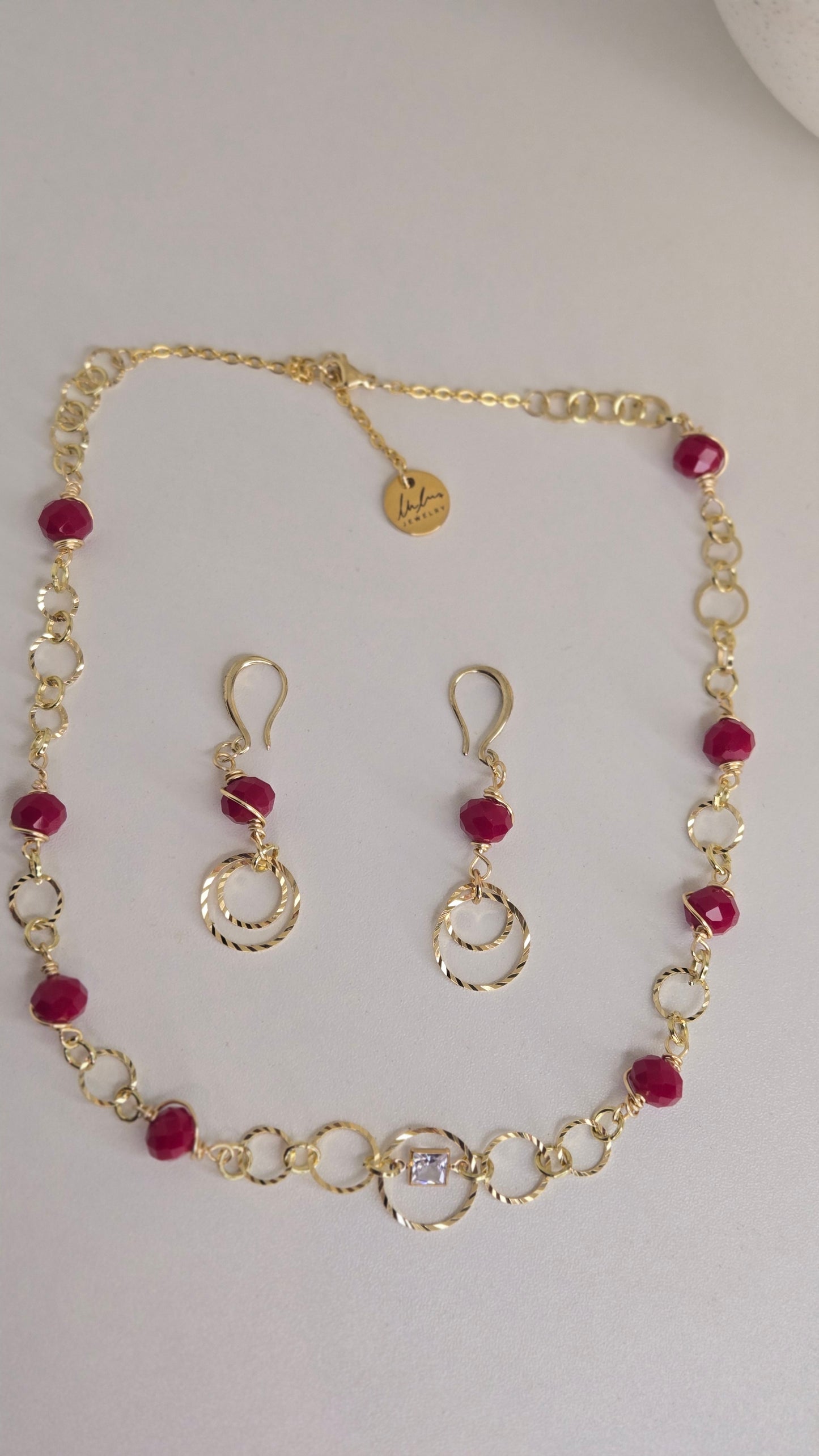 Golden Ruby Charm Set featuring unique charms in array