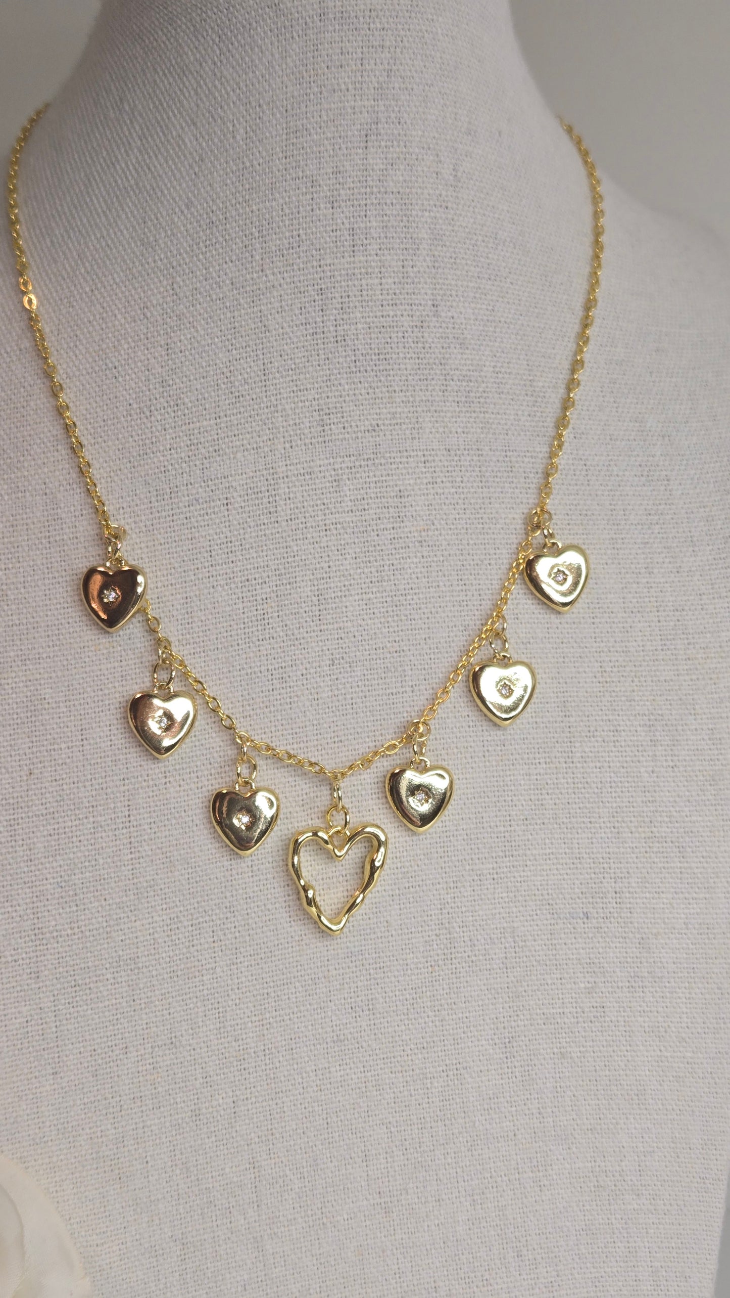 Close-up of the Golden Heart Charm Necklace with intricate details