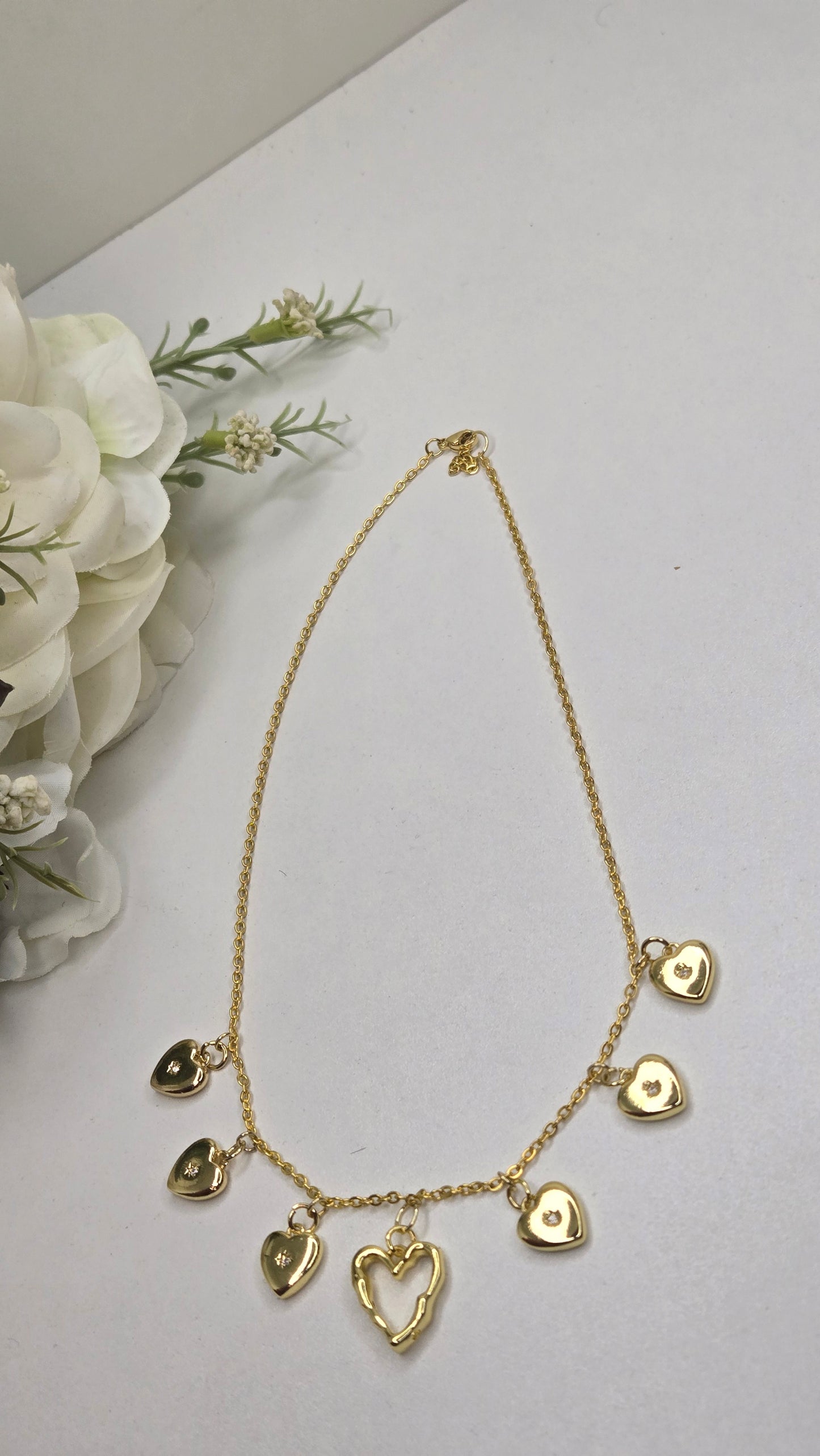 Golden Heart Charm Necklace worn by a model in a casual outfit