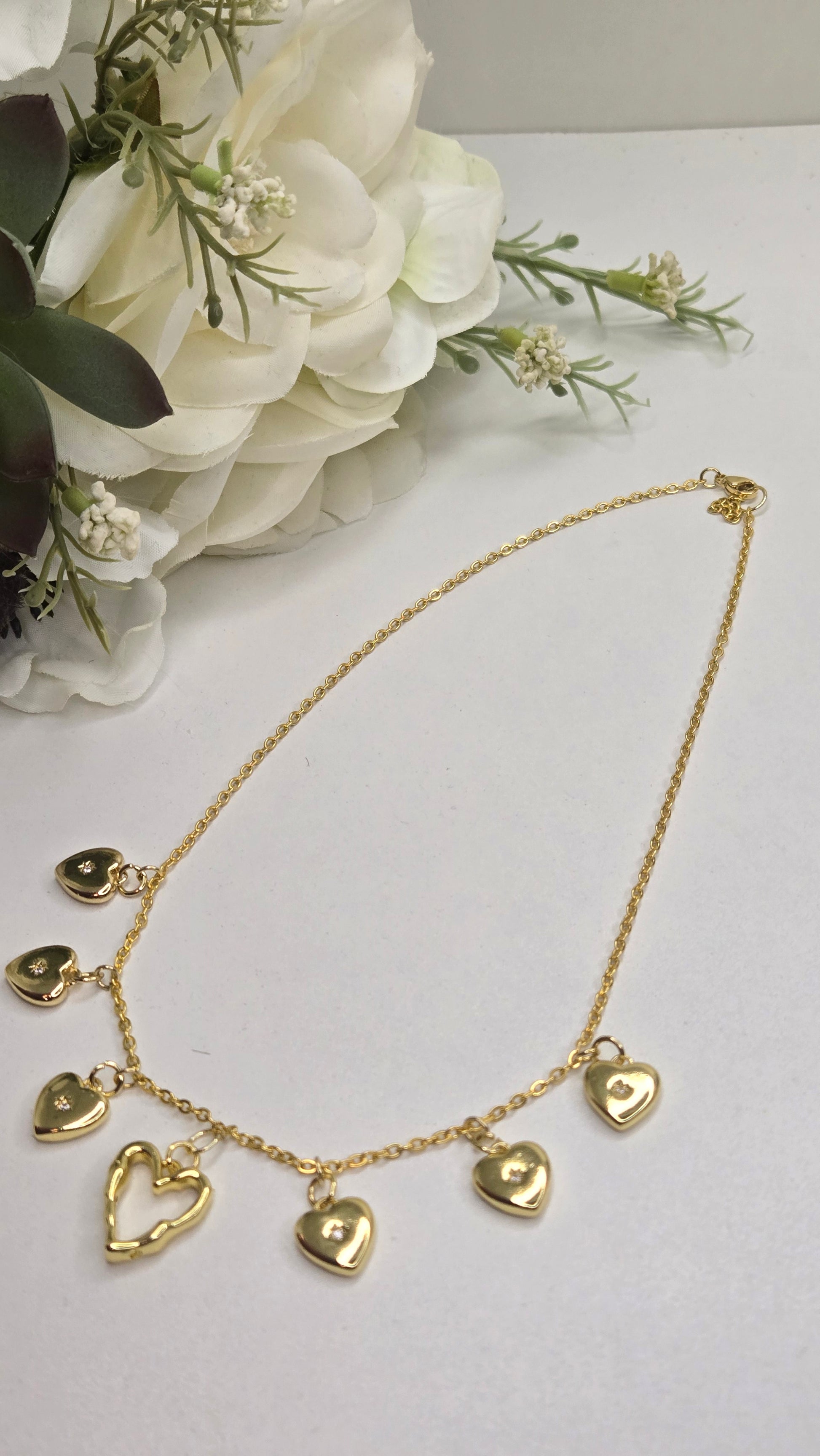 Golden Heart Charm Necklace captured with sparkling background