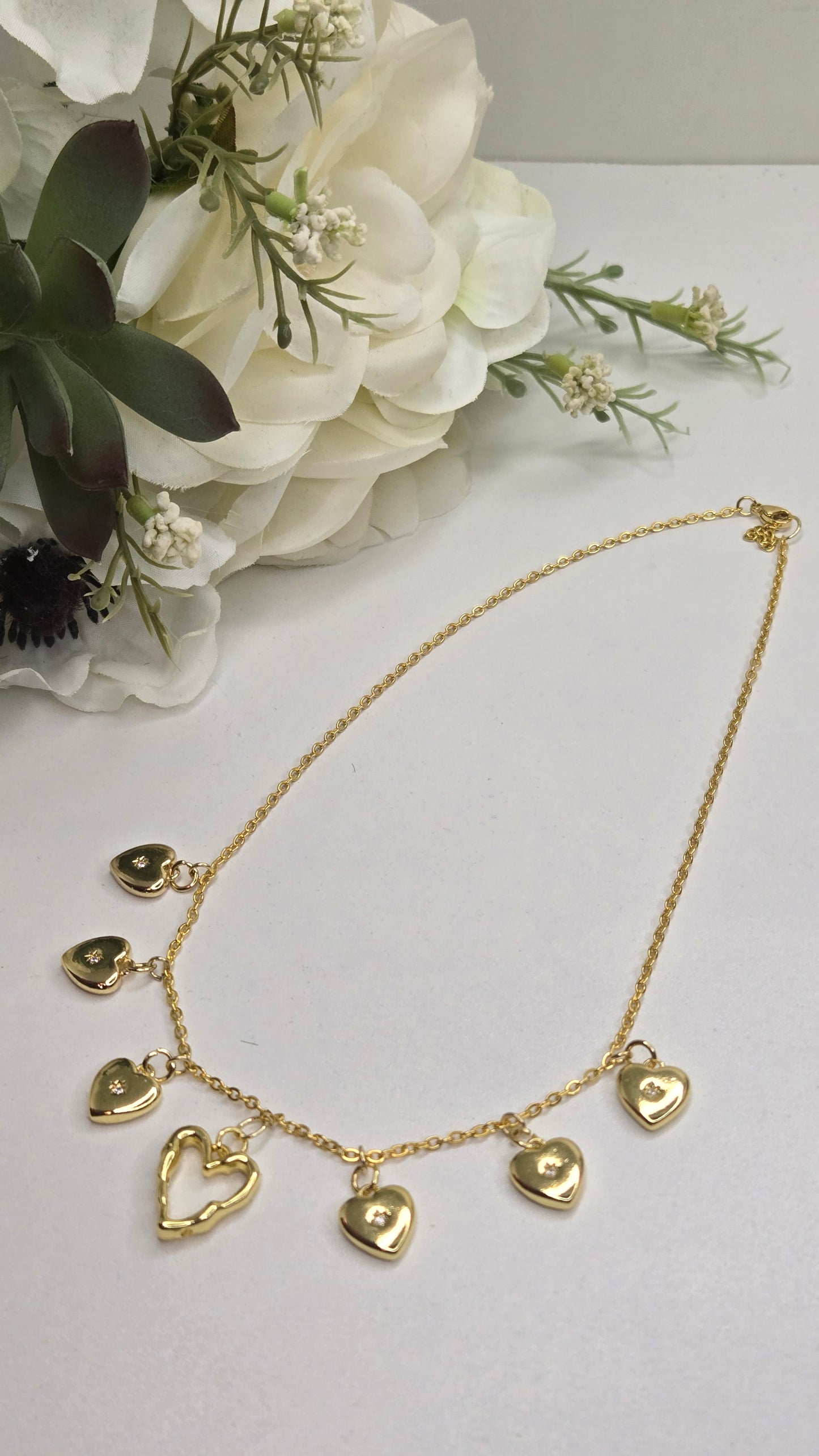 Golden Heart Charm Necklace laid out flat for an elegant display