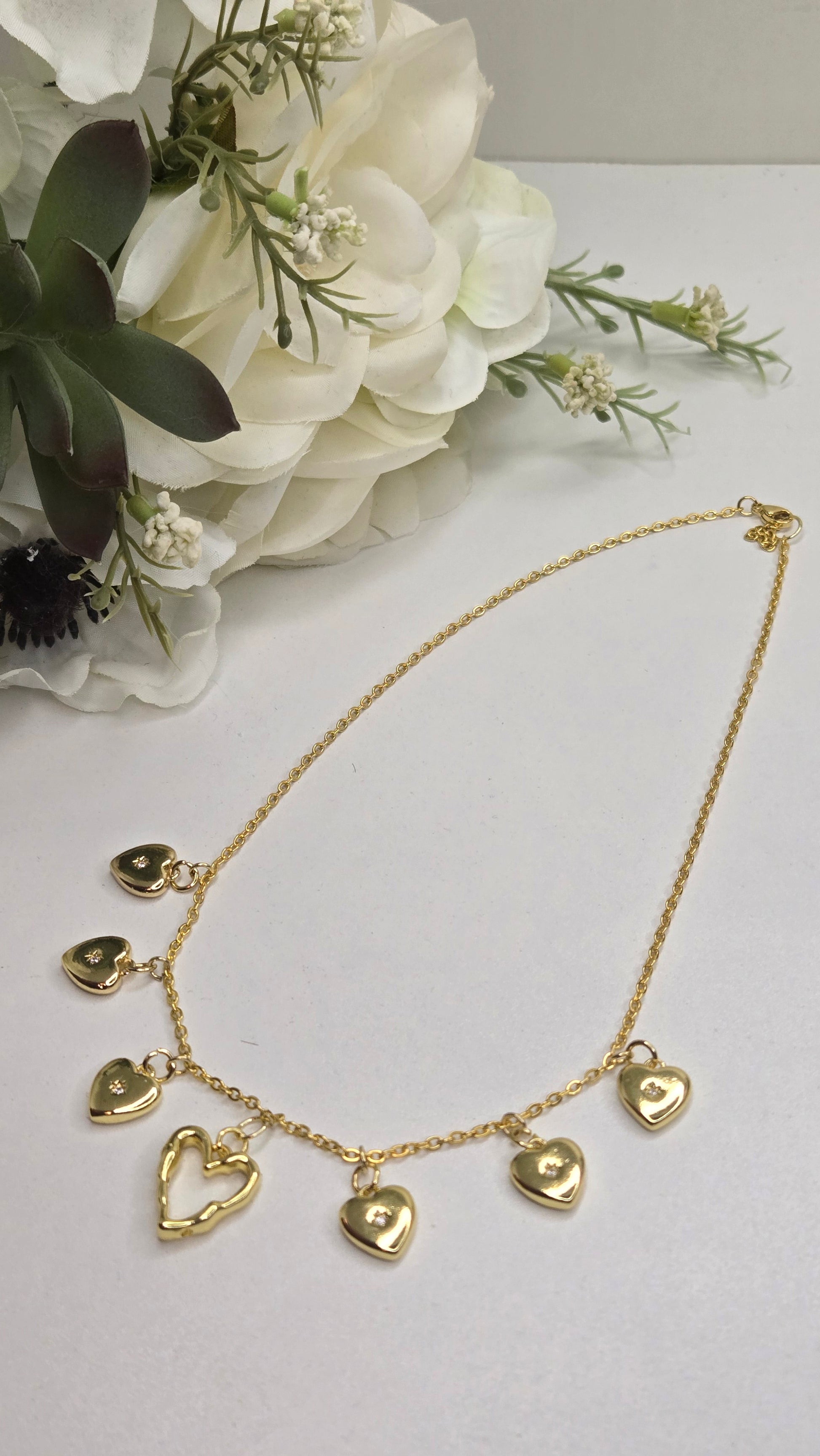 Golden Heart Charm Necklace laid out flat for an elegant display