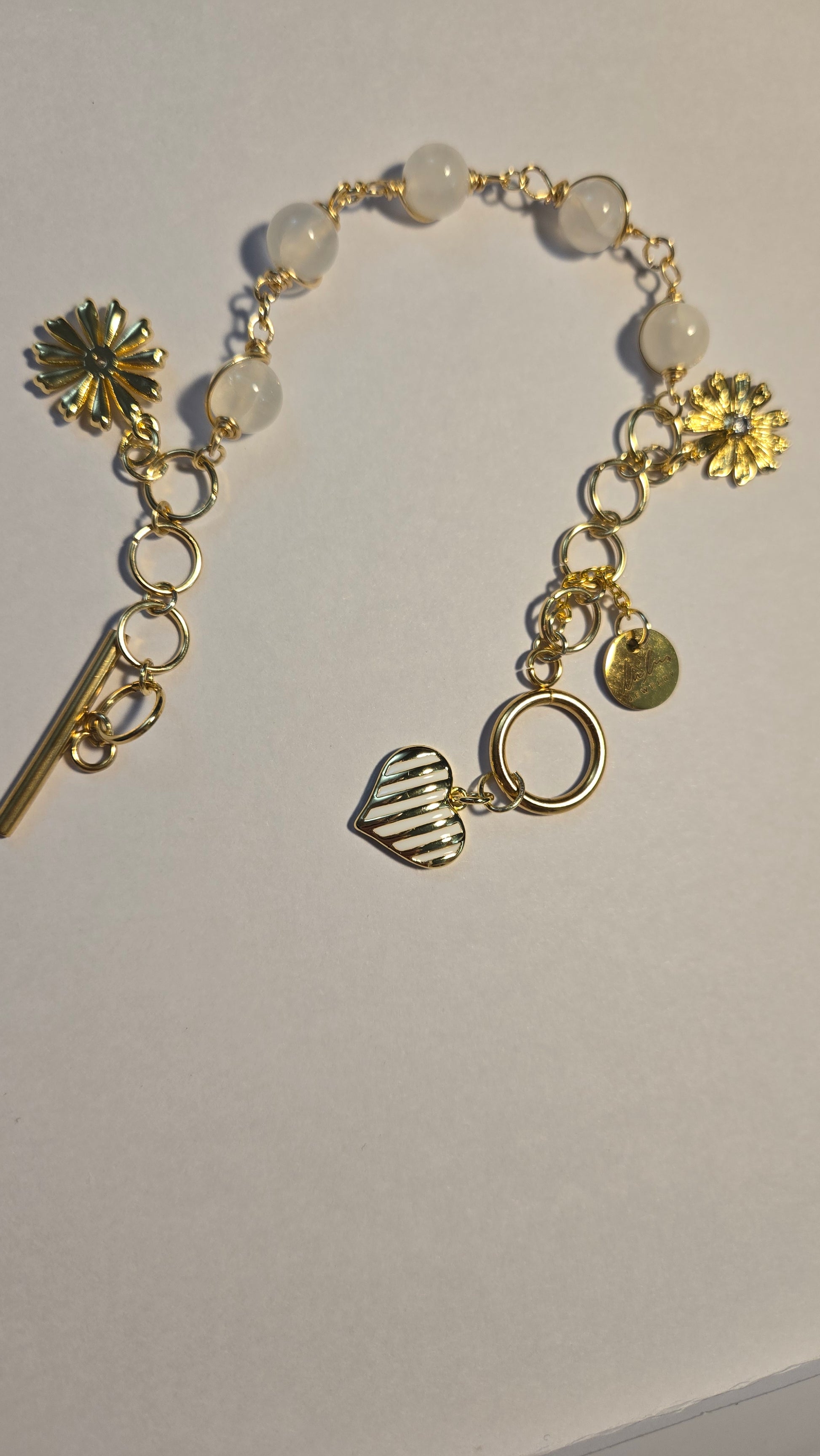 Floral Grace Bracelet displayed with blossoms, showcasing its beauty