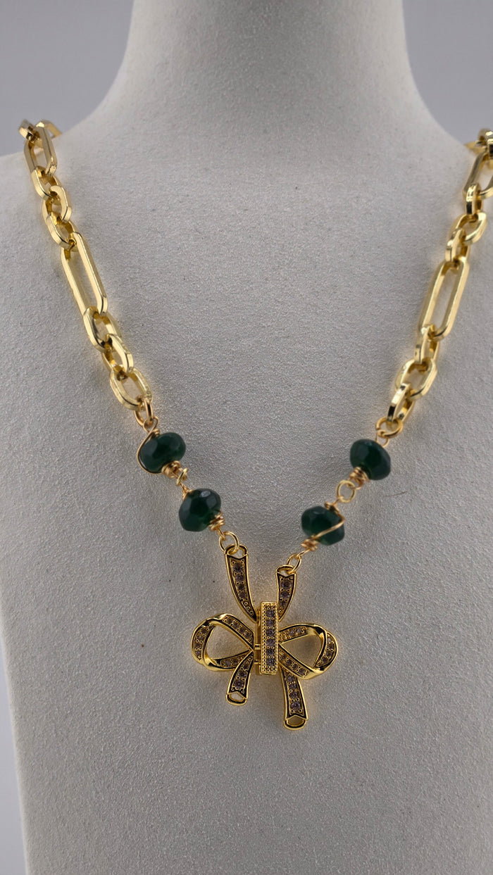 Oriana Bow Necklace, gold-plated with green stones and a crystal-studded bow pendant
