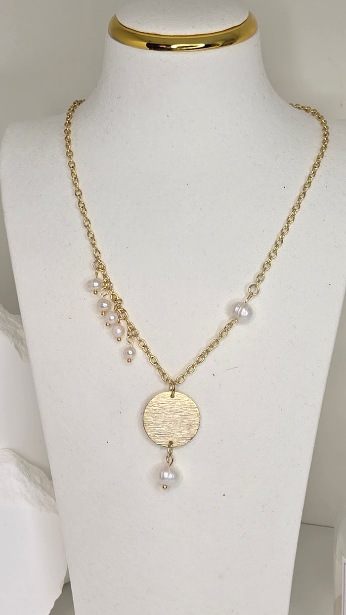 Pearl Light Necklace in gold-tone with a textured circular pendant and dangling pearls