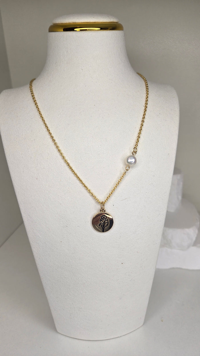 Moon Rose Pendant Necklace with a gold-tone chain, white pearl bead and engraved flower pendant