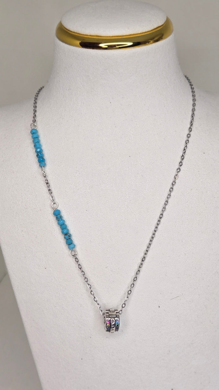 Ocean Magic Necklace with faceted blue beads and a cylindrical charm on a silver-tone chain