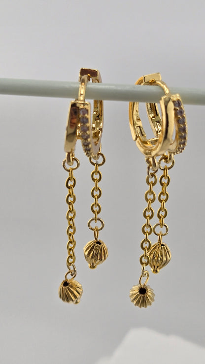 Dancing Gold Earrings with sparkling hoops and dangling gold-tone chains with textured charms