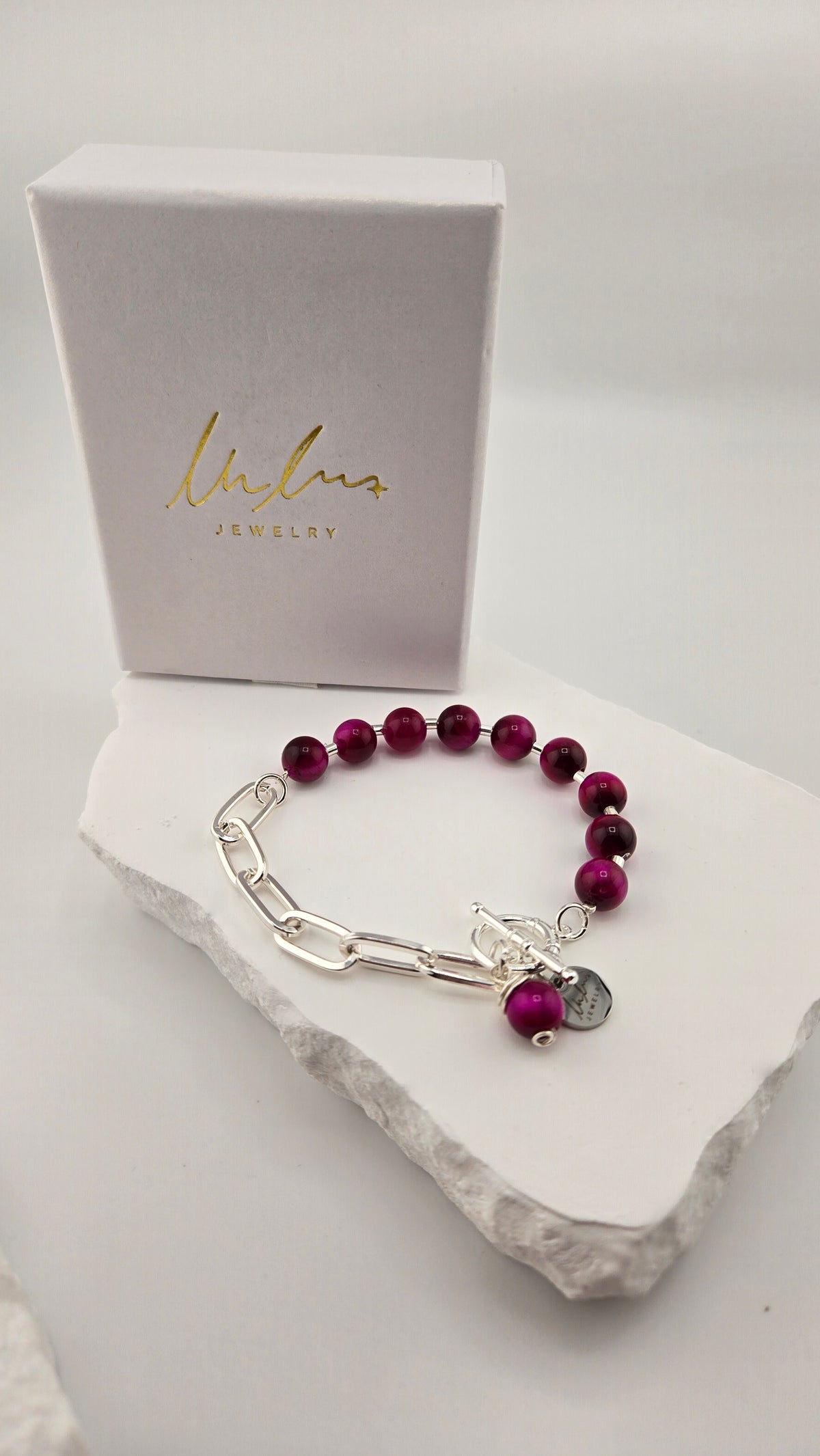 Berry Glow Tiger's Eye Bracelet with fuchsia tiger's eye beads, sterling silver spacers and silver-plated paperclip chain