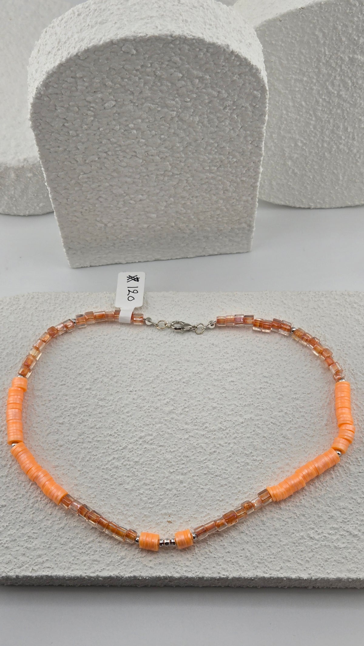 Apricot Glow Necklace, close view of the lobster clasp, clear amber glass beads and apricot-orange disc beads, view 3