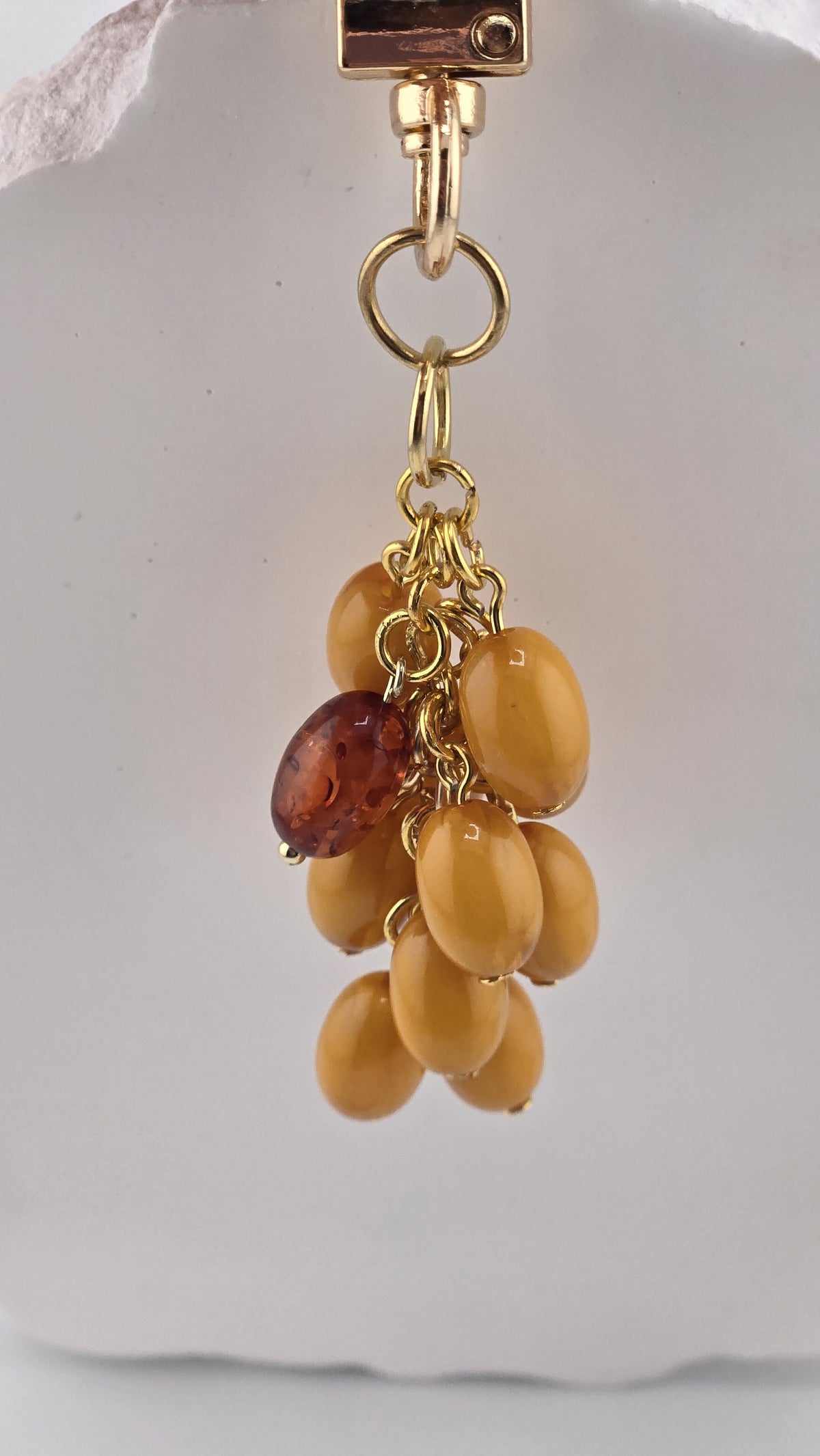 Side view of the Butterscotch Bag Charm bead cluster on gold-plated rings