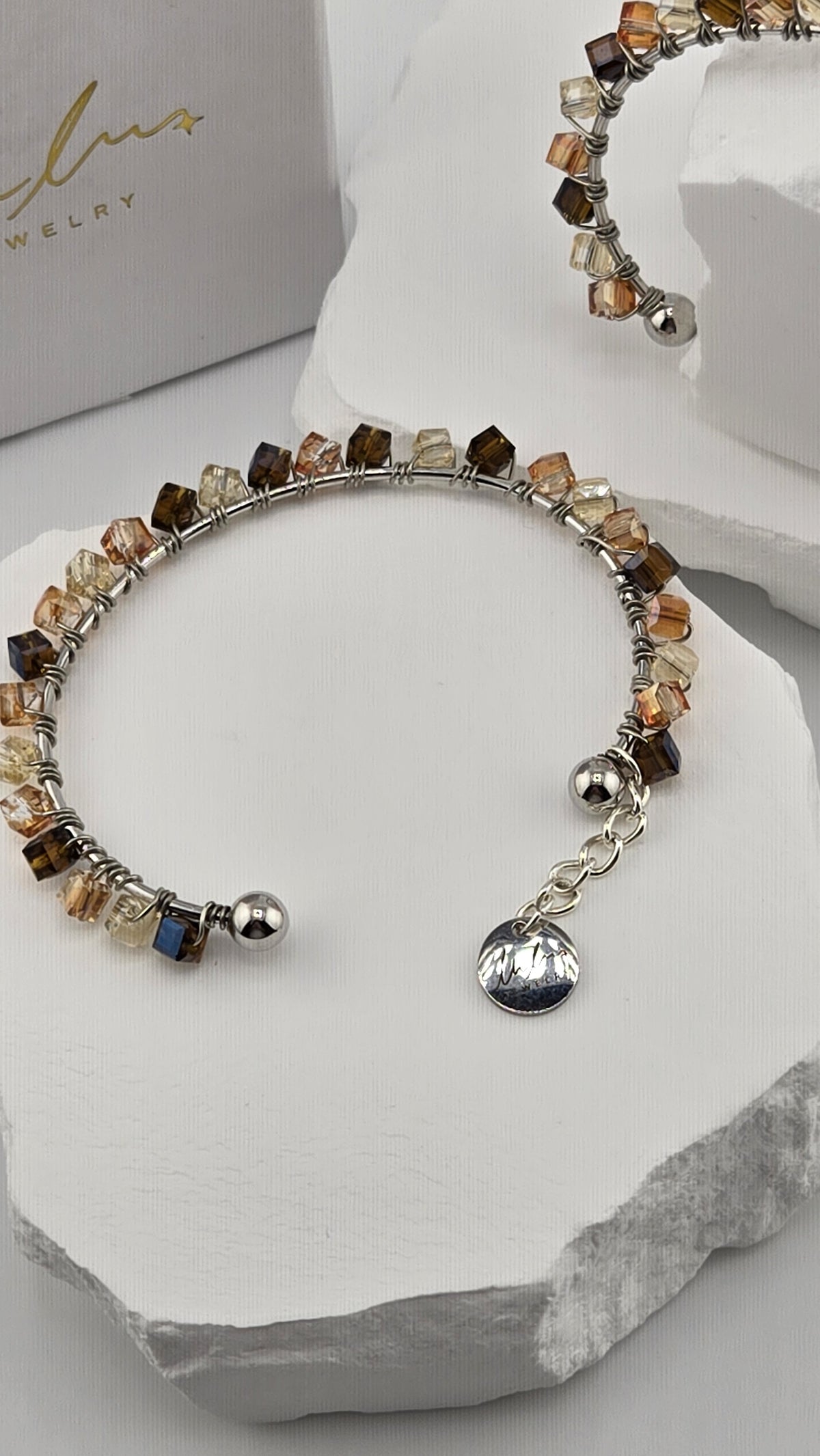 Caramel Prism Bangle with faceted cube beads, ball ends and logo charm, view 2