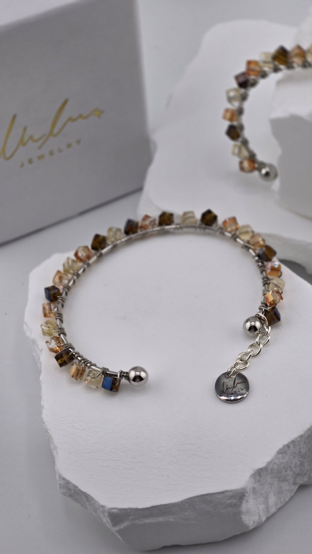 Caramel Prism Bangle with faceted cube beads, ball ends and logo charm, view 3