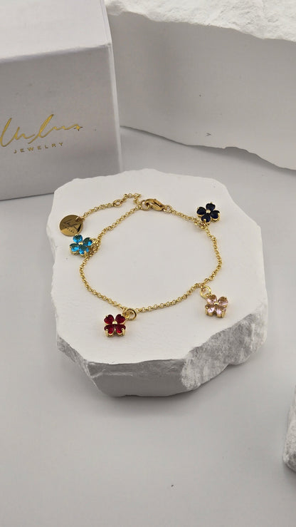 Confetti Charm Bracelet with four colorful heart-petal flower charms on a gold-plated chain