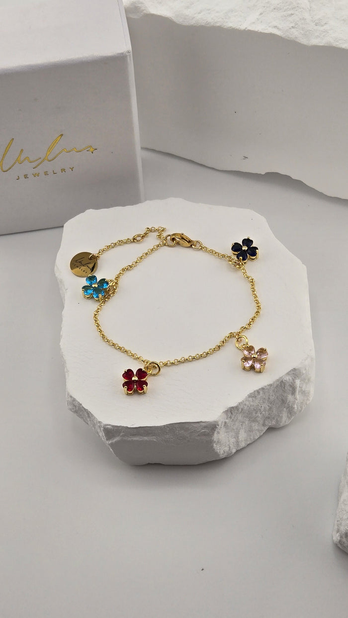 Confetti Charm Bracelet with four colorful heart-petal flower charms on a gold-plated chain