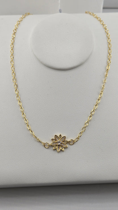 Dahlia Gold-Filled Necklace with a sparkling gold flower centerpiece on a necklace stand