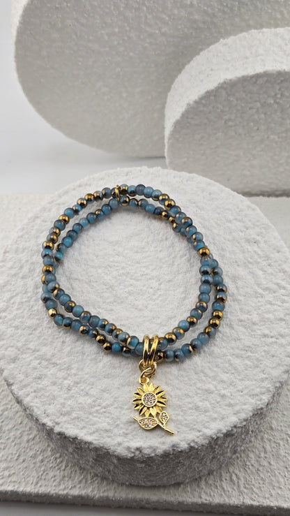 Close-up of the Denim Sunbeam Bracelet sunflower charm with tiny sparkling stones