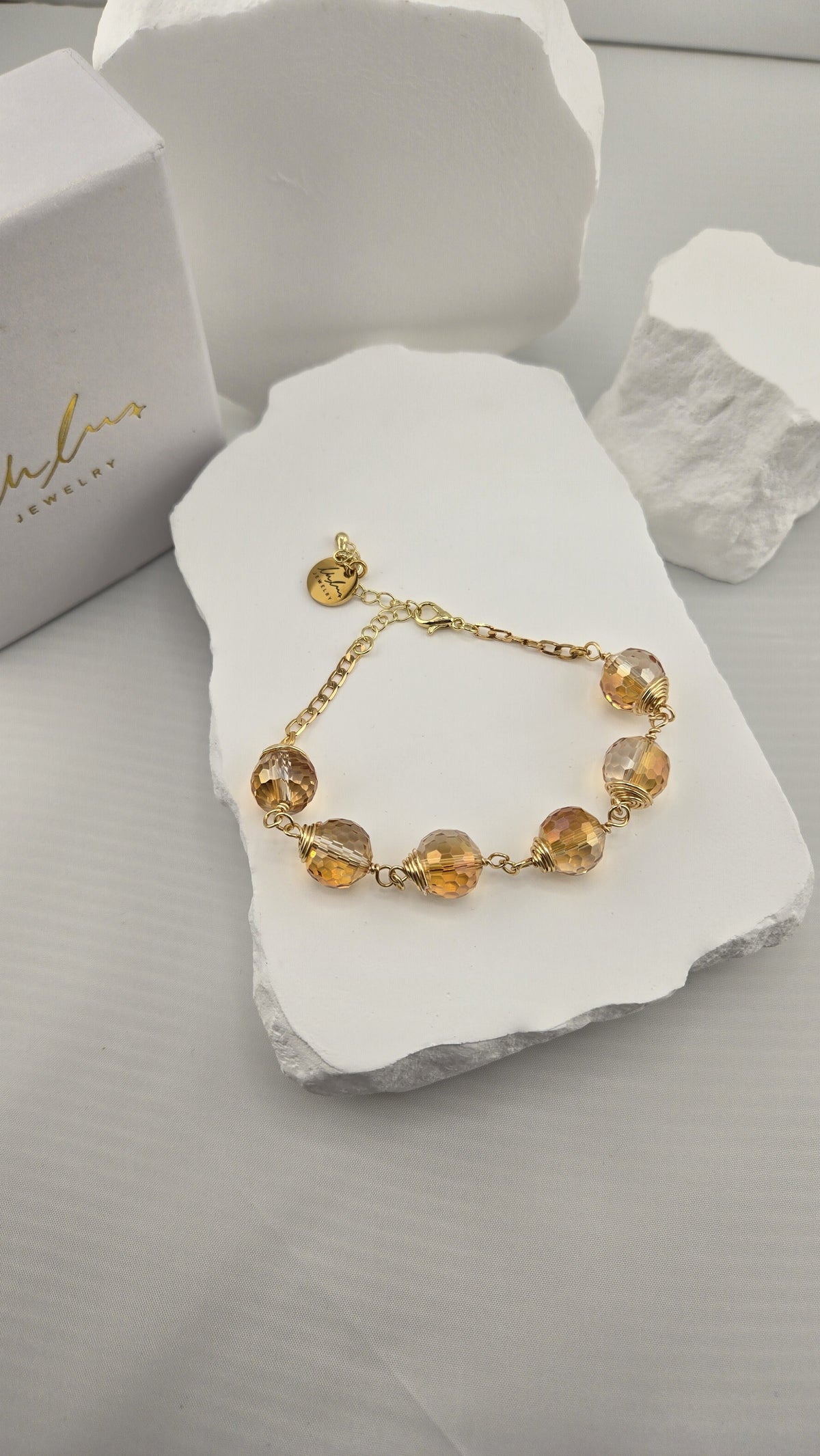 Firefly Orb Bracelet beside the LuluTouch gift box