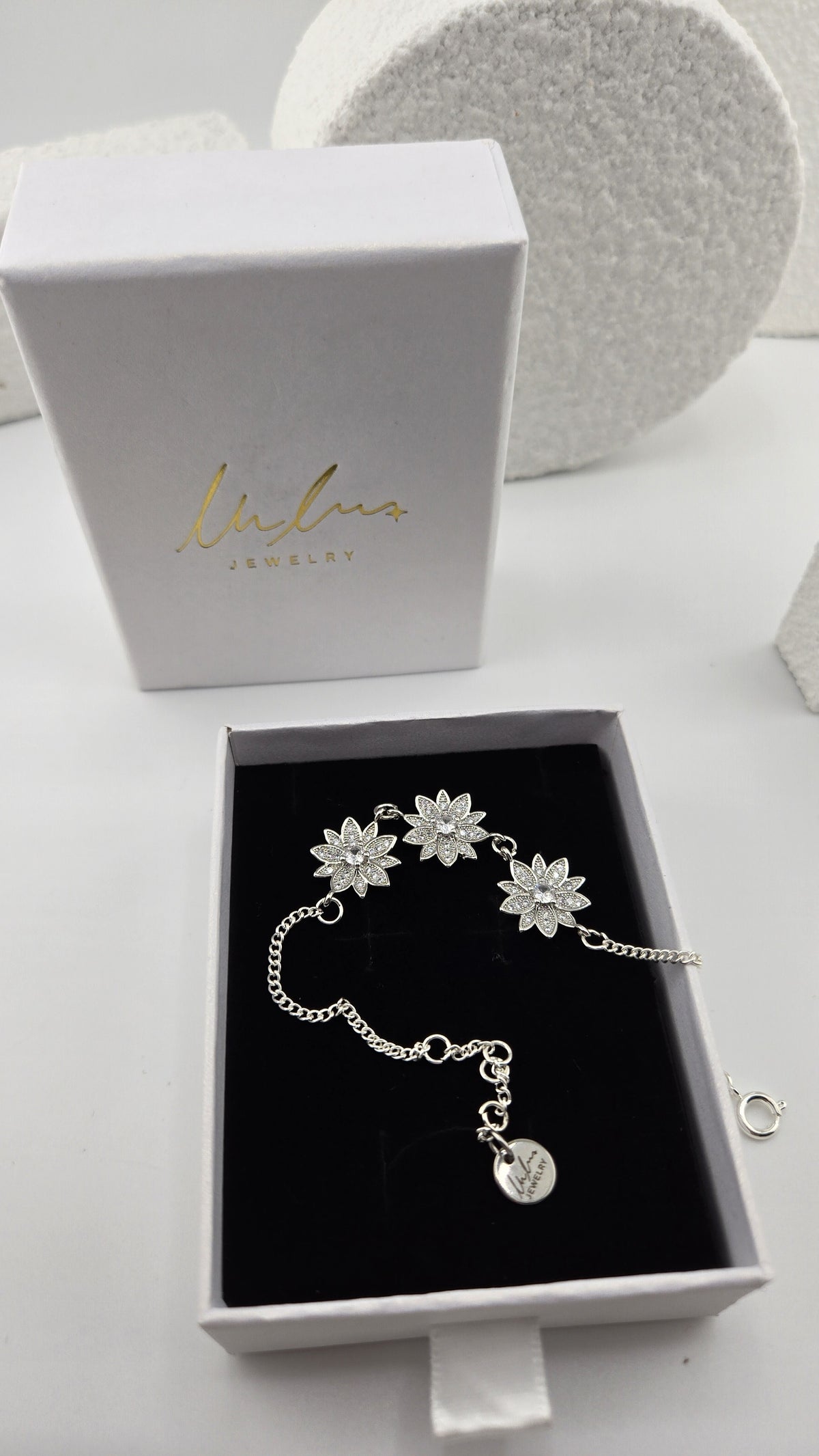 Frosted Lotus Bracelet in a LuluTouch gift box, three silver-tone lotus flowers set with cubic zirconia on a curb chain