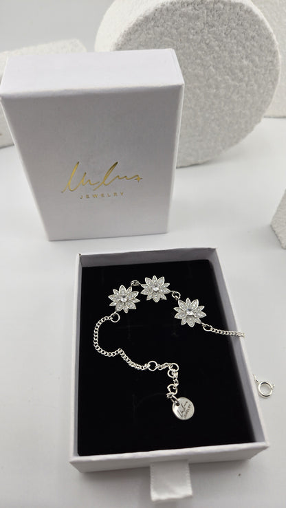 Frosted Lotus Bracelet in a LuluTouch gift box, three silver-tone lotus flowers set with cubic zirconia on a curb chain
