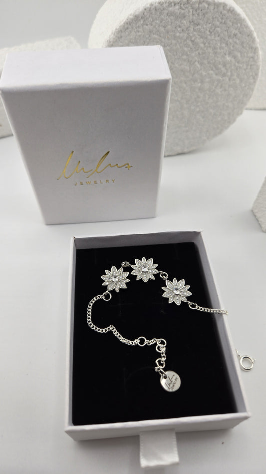 Frosted Lotus Bracelet in a LuluTouch gift box, three silver-tone lotus flowers set with cubic zirconia on a curb chain