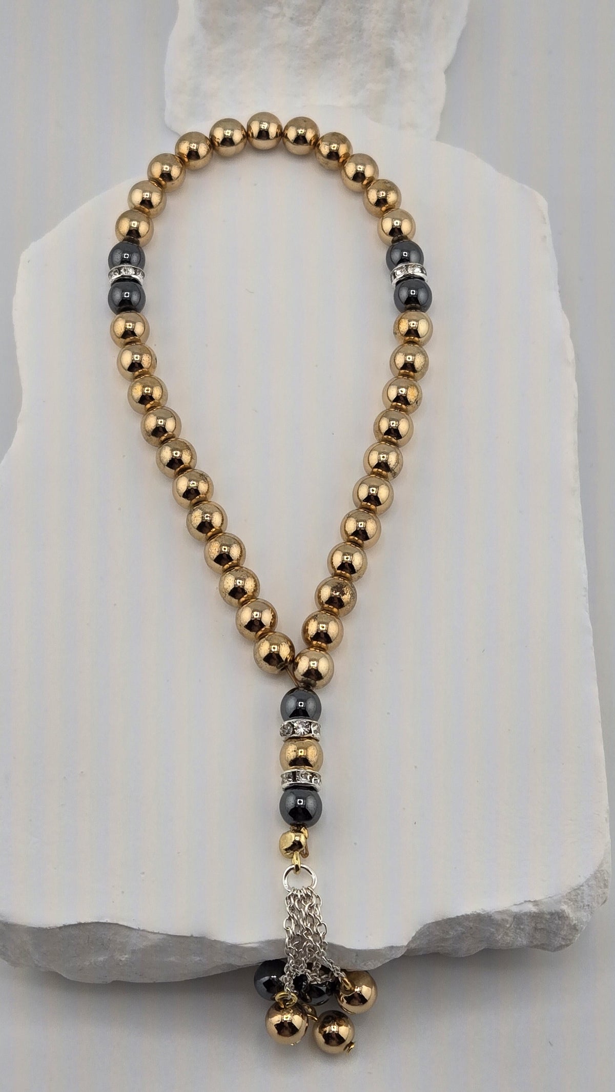Gilded Dusk Tasbih with gold-tone and dark gray hematite beads