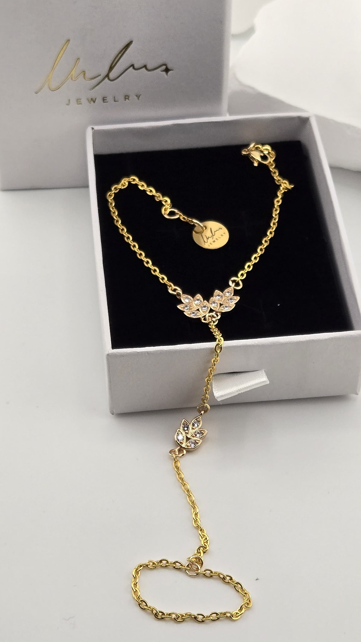 Golden Laurel Hand Chain in a Lulutouch gift box, gold-tone chain with sparkling leaf charms