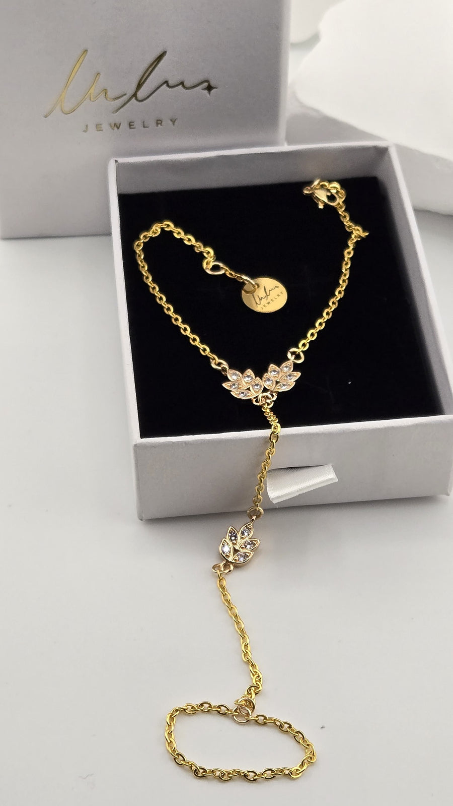 Golden Laurel Hand Chain in a Lulutouch gift box, gold-tone chain with sparkling leaf charms