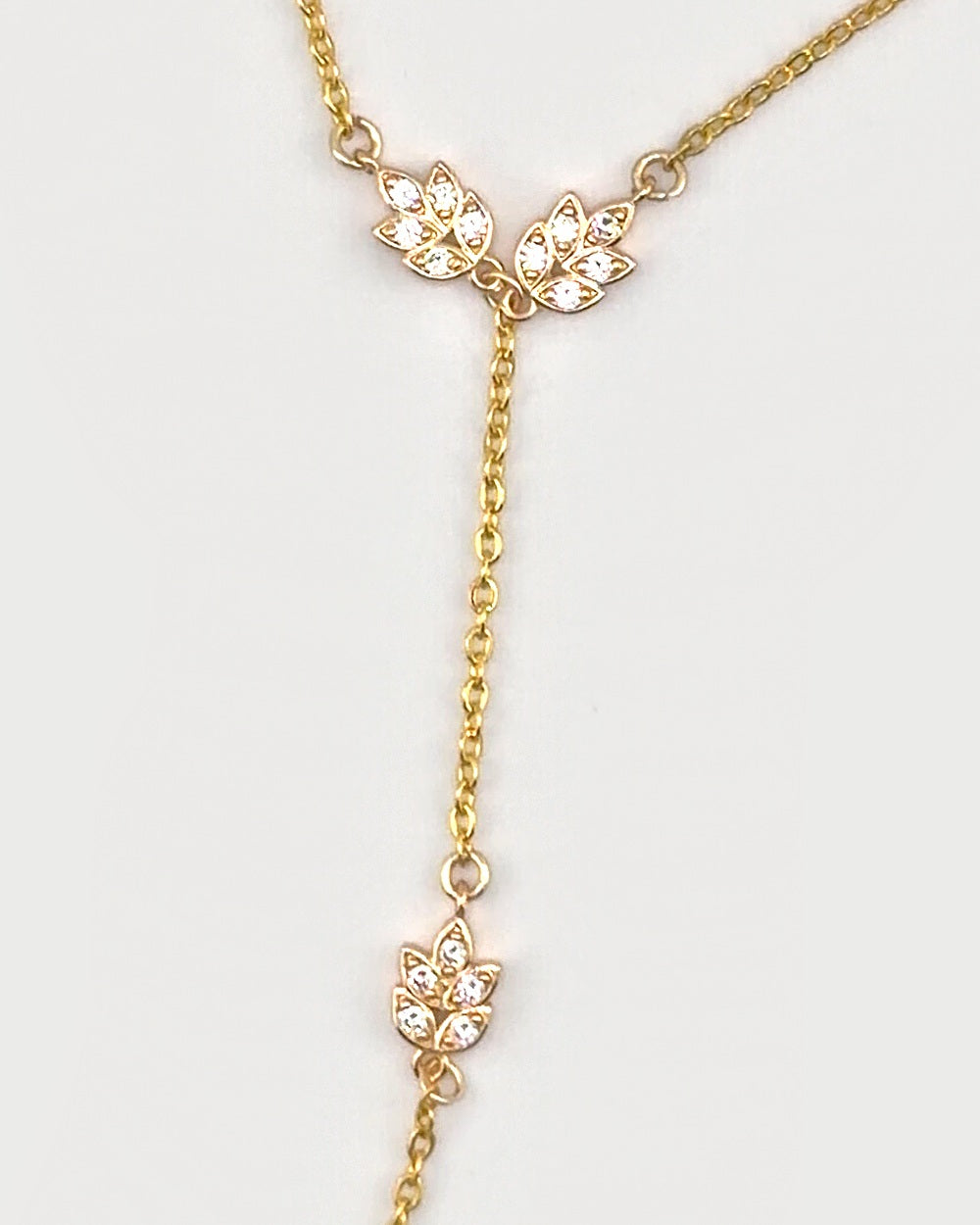 Close-up of the sparkling leaf charms on the Golden Laurel Hand Chain