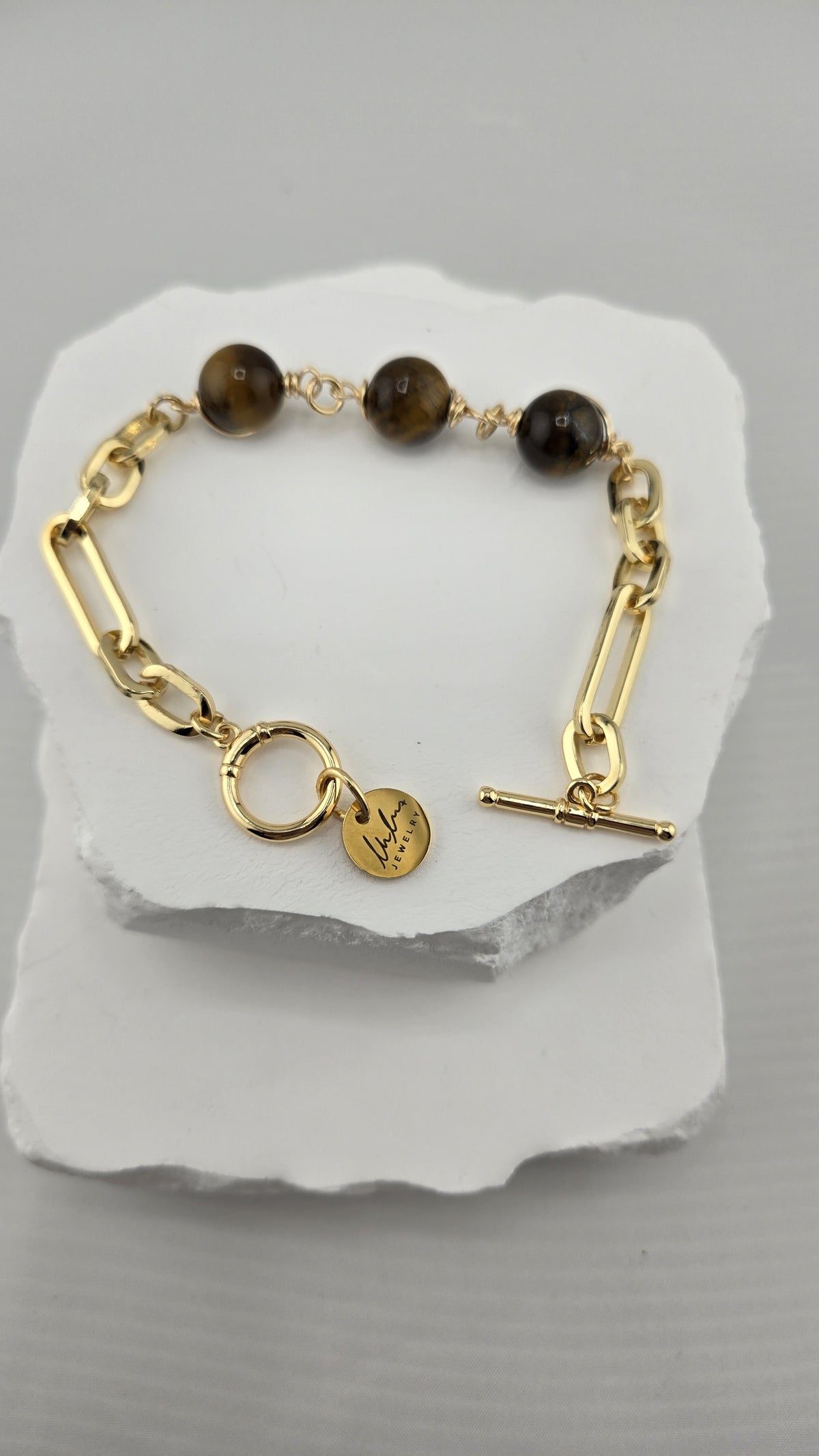 Hazel Paperclip Bracelet with three golden-brown beads on a gold-plated paperclip chain