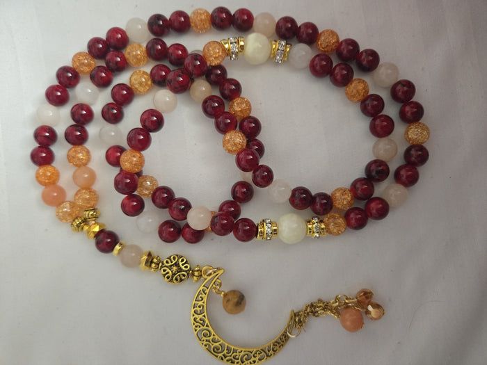 Golden Sunset Tasbih with red, orange and cream beads and a gold-tone crescent moon charm