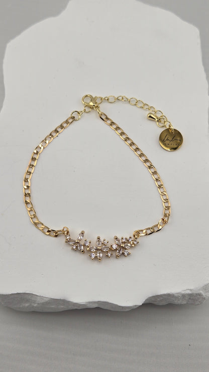 Jasmine Sprig Bracelet laid on a white stone with extender and LuluTouch tag