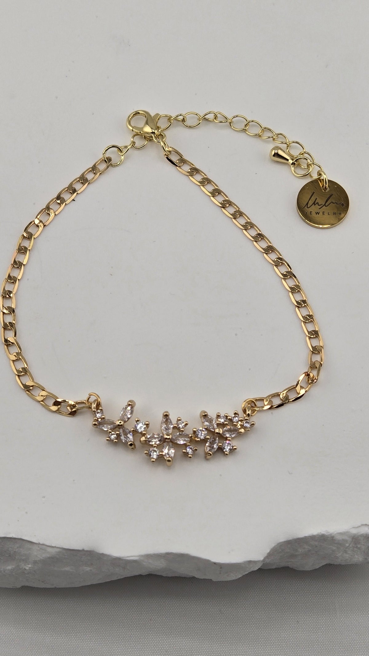 Jasmine Sprig Bracelet with a three-flower centerpiece of clear stones on a gold-plated chain