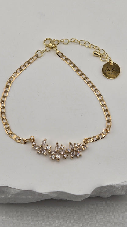 Jasmine Sprig Bracelet with a three-flower centerpiece of clear stones on a gold-plated chain