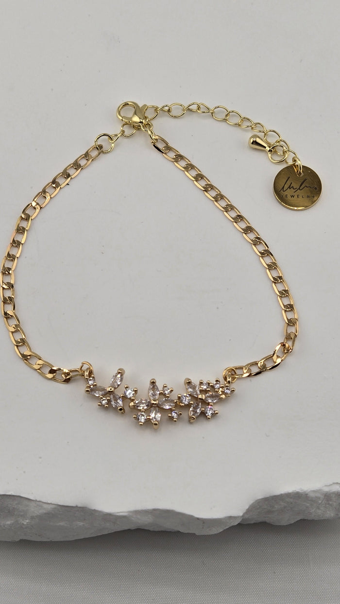 Jasmine Sprig Bracelet with a three-flower centerpiece of clear stones on a gold-plated chain