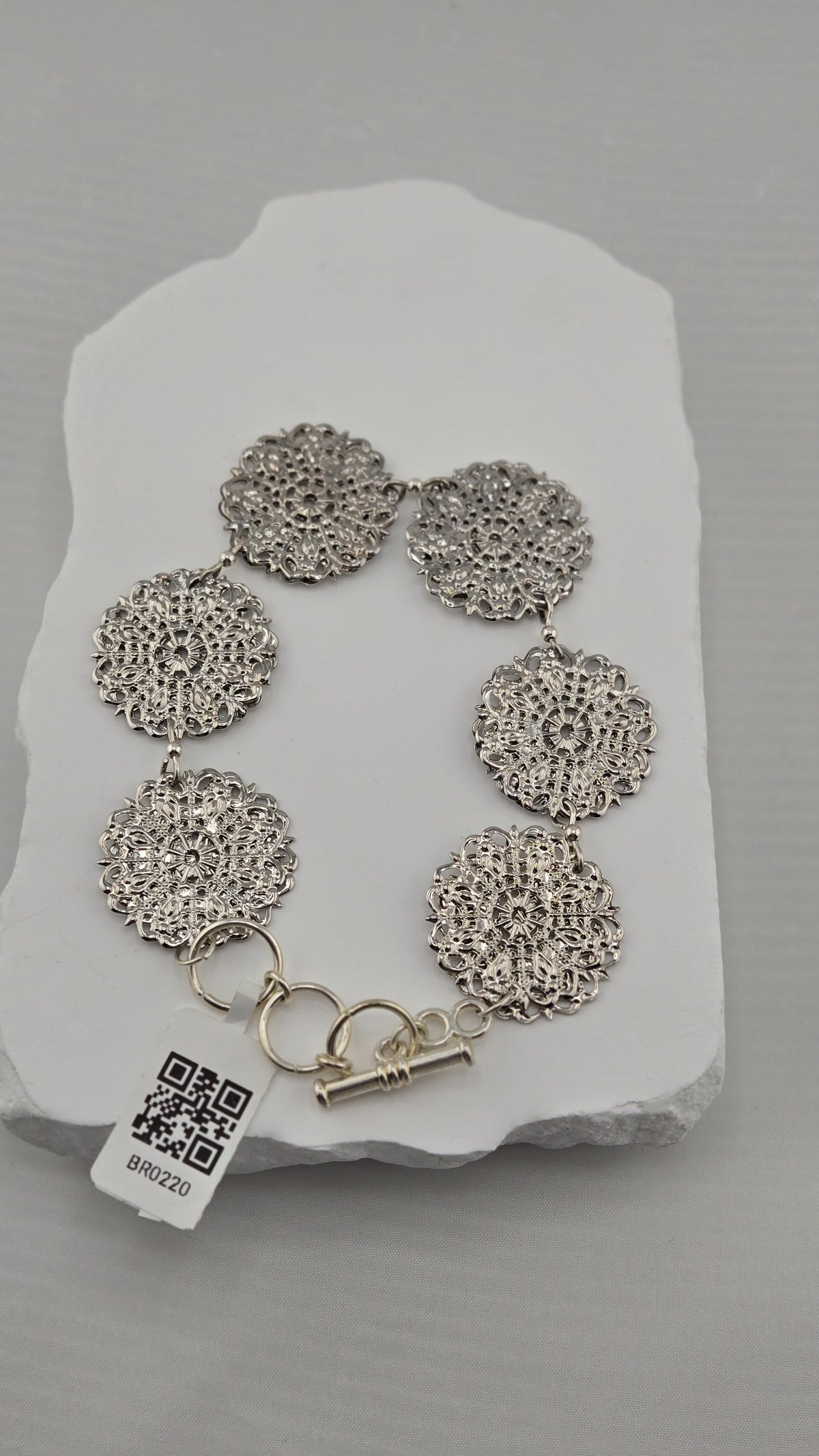 Lace Medallion Bracelet with six silver-tone openwork medallions and toggle clasp