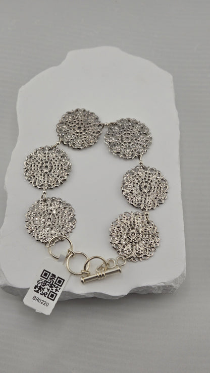 Lace Medallion Bracelet with six silver-tone openwork medallions and toggle clasp