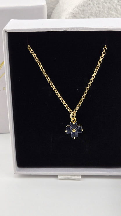 Meadow Clover Necklace in navy, four-leaf clover pendant with heart-shaped navy stones on a gold-plated chain in a LuluTouch gift box