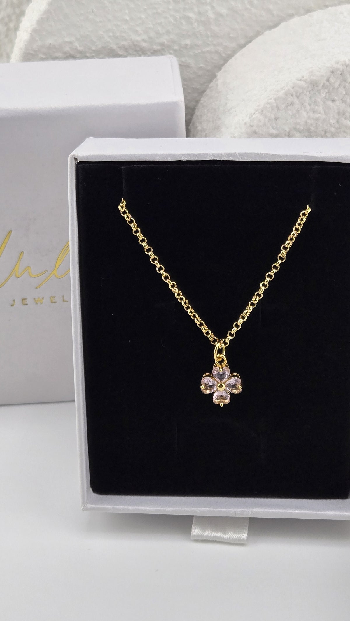 Meadow Clover Necklace in pink, four-leaf clover pendant with heart-shaped pink stones on a gold-plated chain in a LuluTouch gift box