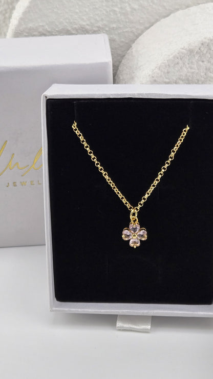 Meadow Clover Necklace in pink, four-leaf clover pendant with heart-shaped pink stones on a gold-plated chain in a LuluTouch gift box