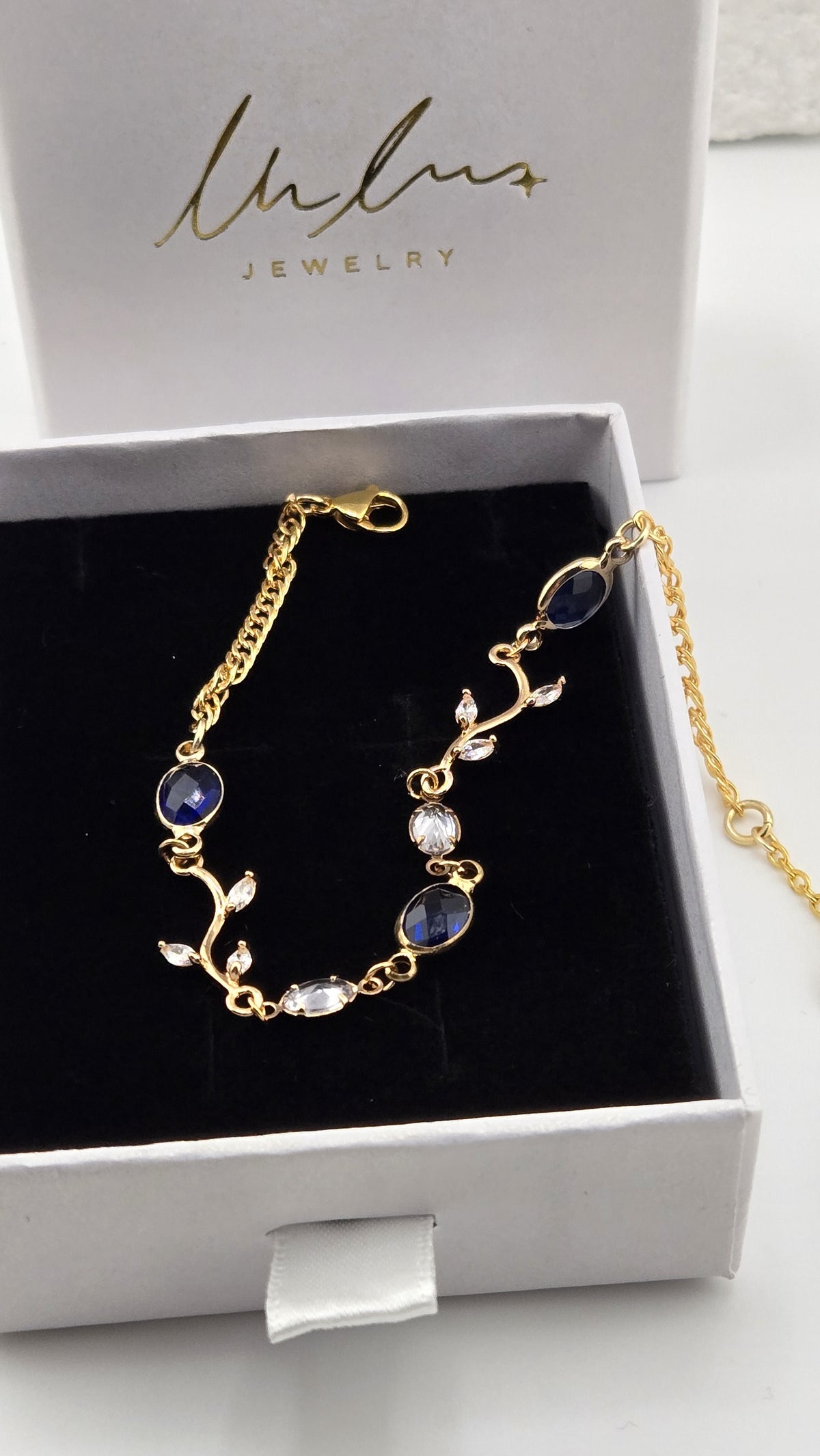 Navy Ivy Bracelet in a LuluTouch gift box, gold-plated ivy branches with clear marquise leaves and faceted navy and clear oval stones