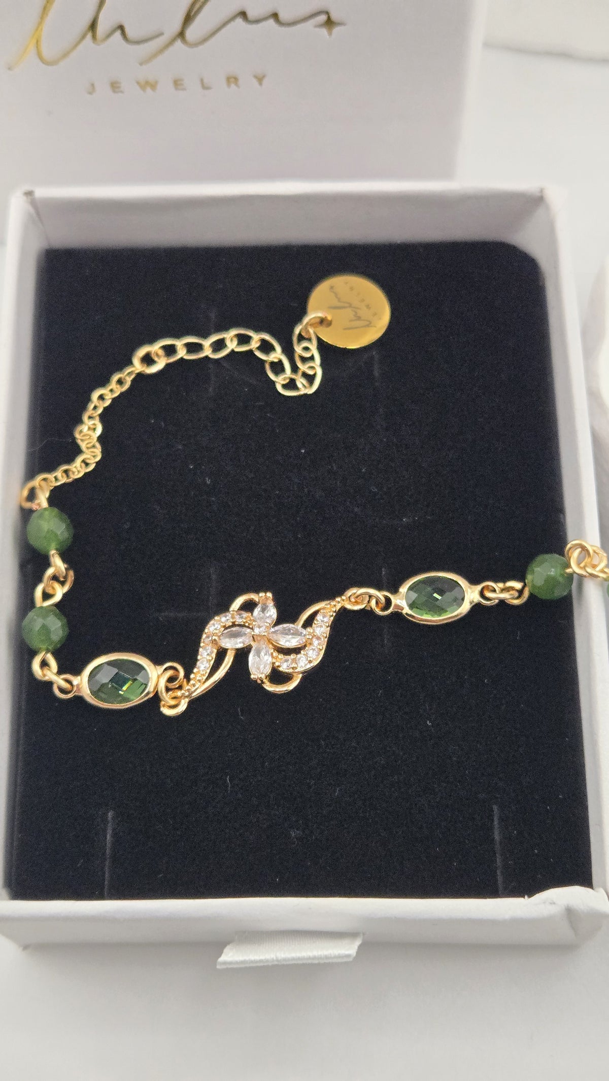 Close-up of the Olive Swirl Bracelet flower and green oval stones