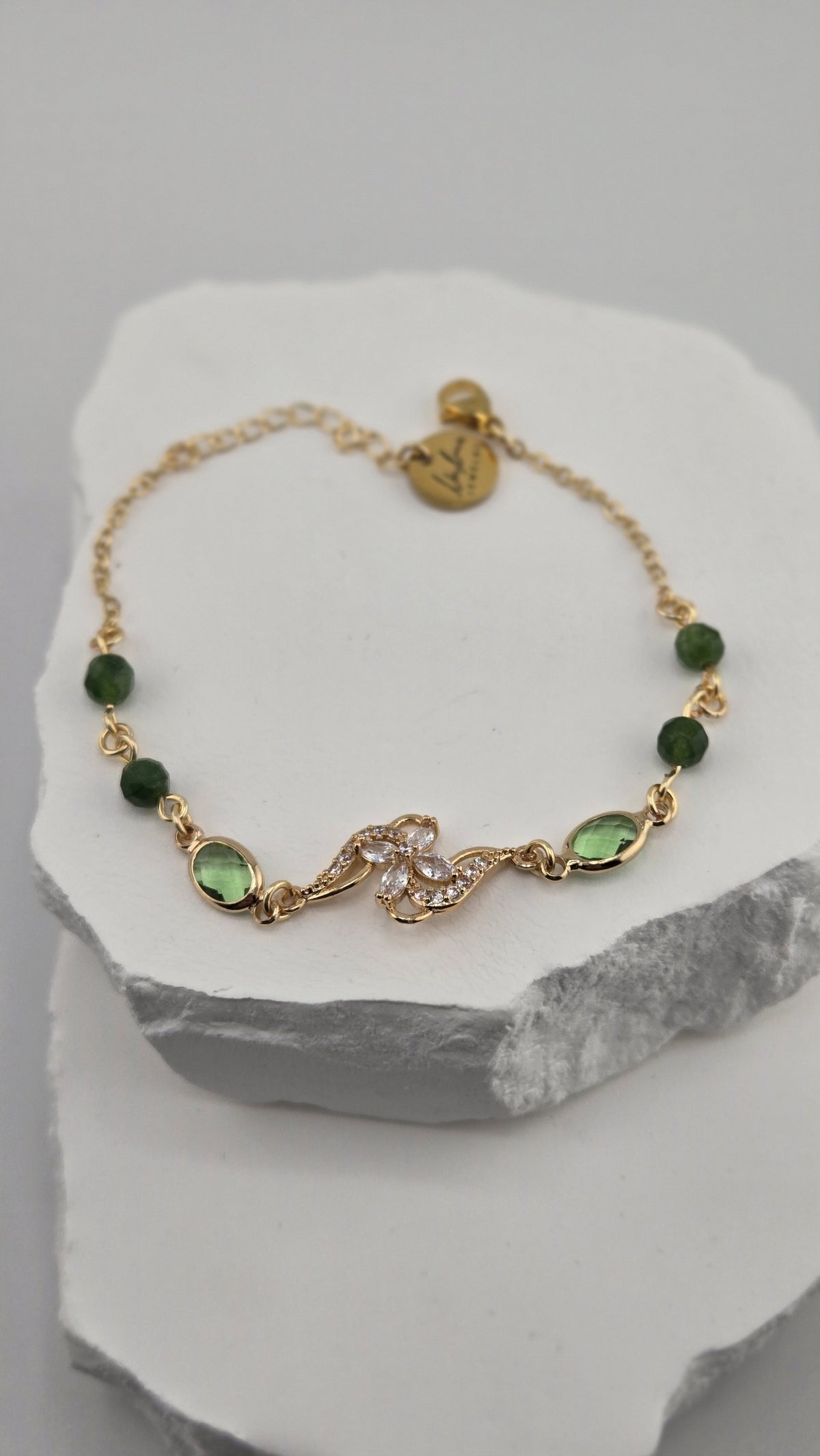 Olive Swirl Bracelet with deep green beads and a gold flower centerpiece