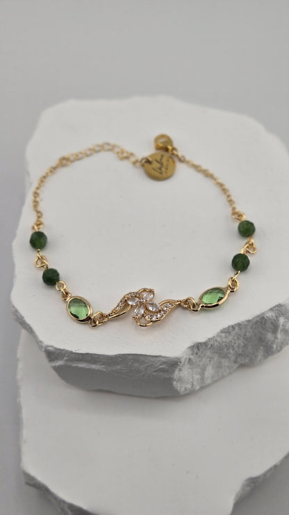 Olive Swirl Bracelet with deep green beads and a gold flower centerpiece
