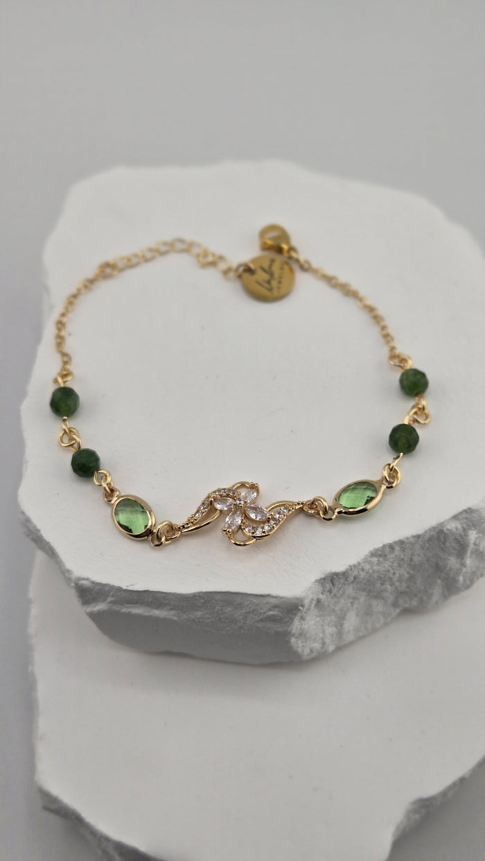 Olive Swirl Bracelet with deep green beads and a gold flower centerpiece