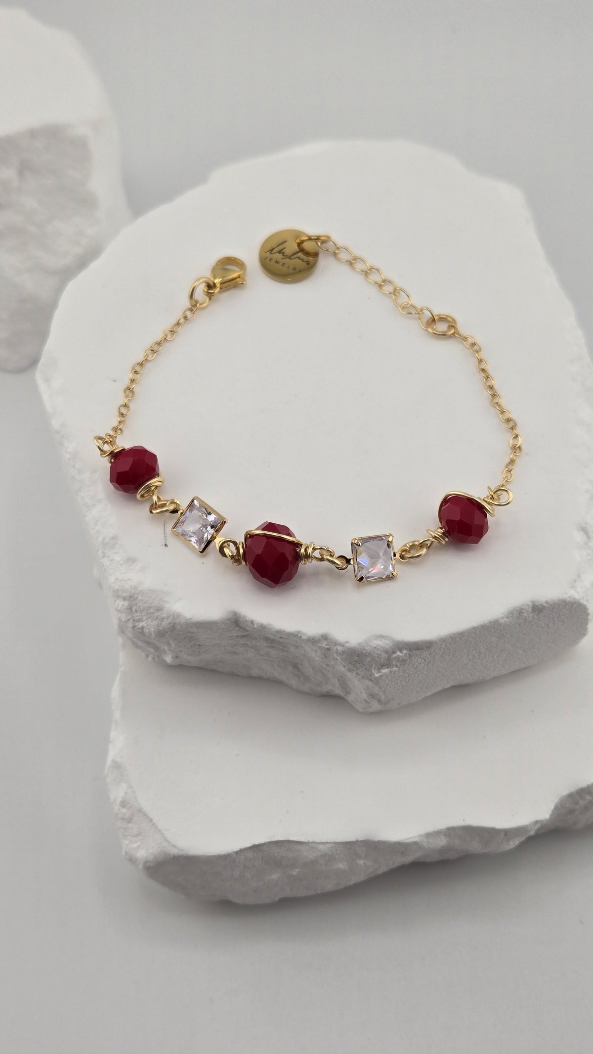 Detail of the Poppy Facet Bracelet with wire-wrapped red beads and square clear stones